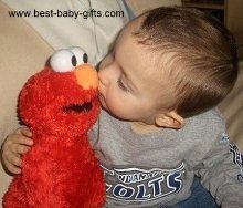 baby boy kissing a cuddly Elmo puppet