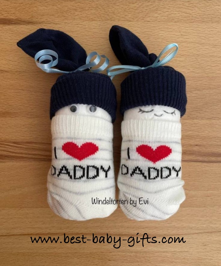a pair of diaper babies with "I love daddy" socks