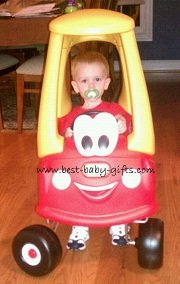baby boy in a red Little Tykes Coupe, boy is sucking on a pacifier