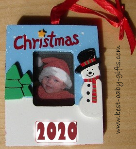 a wooden Christmas tree hanger with a  baby girl photo wearing a Christmas hat