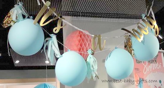 It's a boy garland and blue balloons hanging from the ceiling