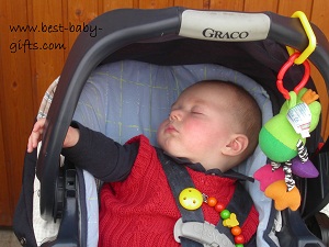 a baby boy sleeping in his car seat