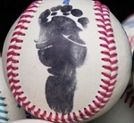 a baseball with baby's footprint a baseball with baby's footprint