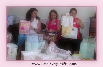 3 moms-to-be (including myself ate the left) at an office baby shower party unpacking their presents
