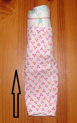 rolled diaper and fixing a washcloth around it