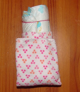 rolled diaper and how to fix the washcloth around it, folded up