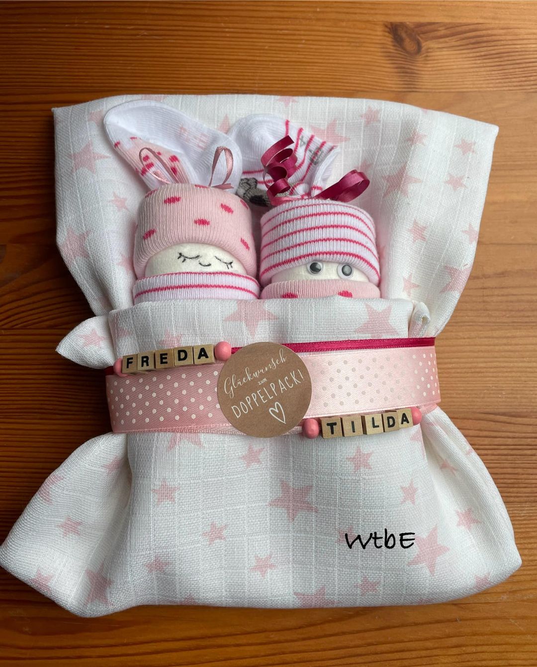 diaper babies wrapped in a burp cloth for baby girl twins, personalized with wooden letters for Freda and Tilda