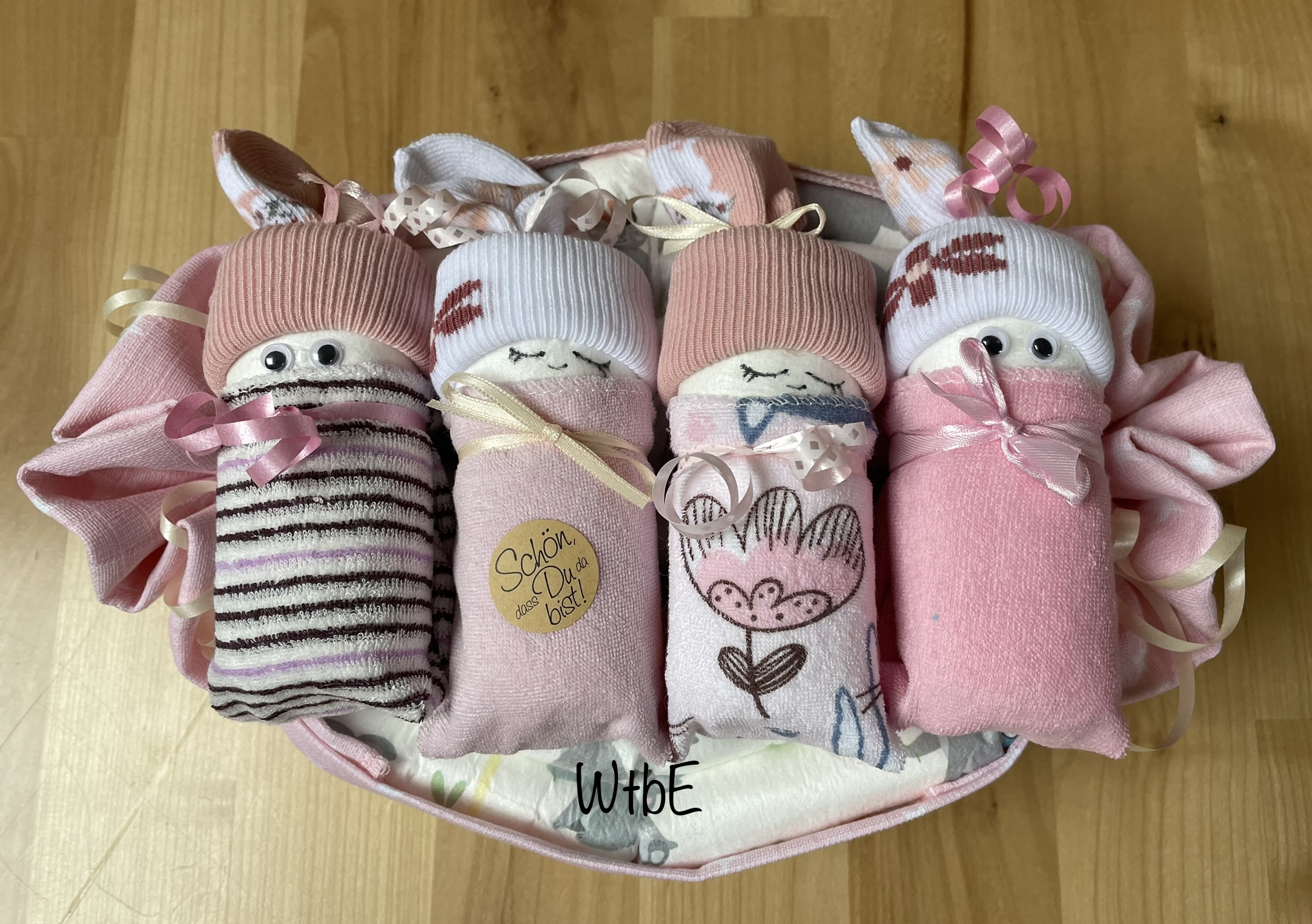 diaper babies placed in a burp cloth filled with diapers