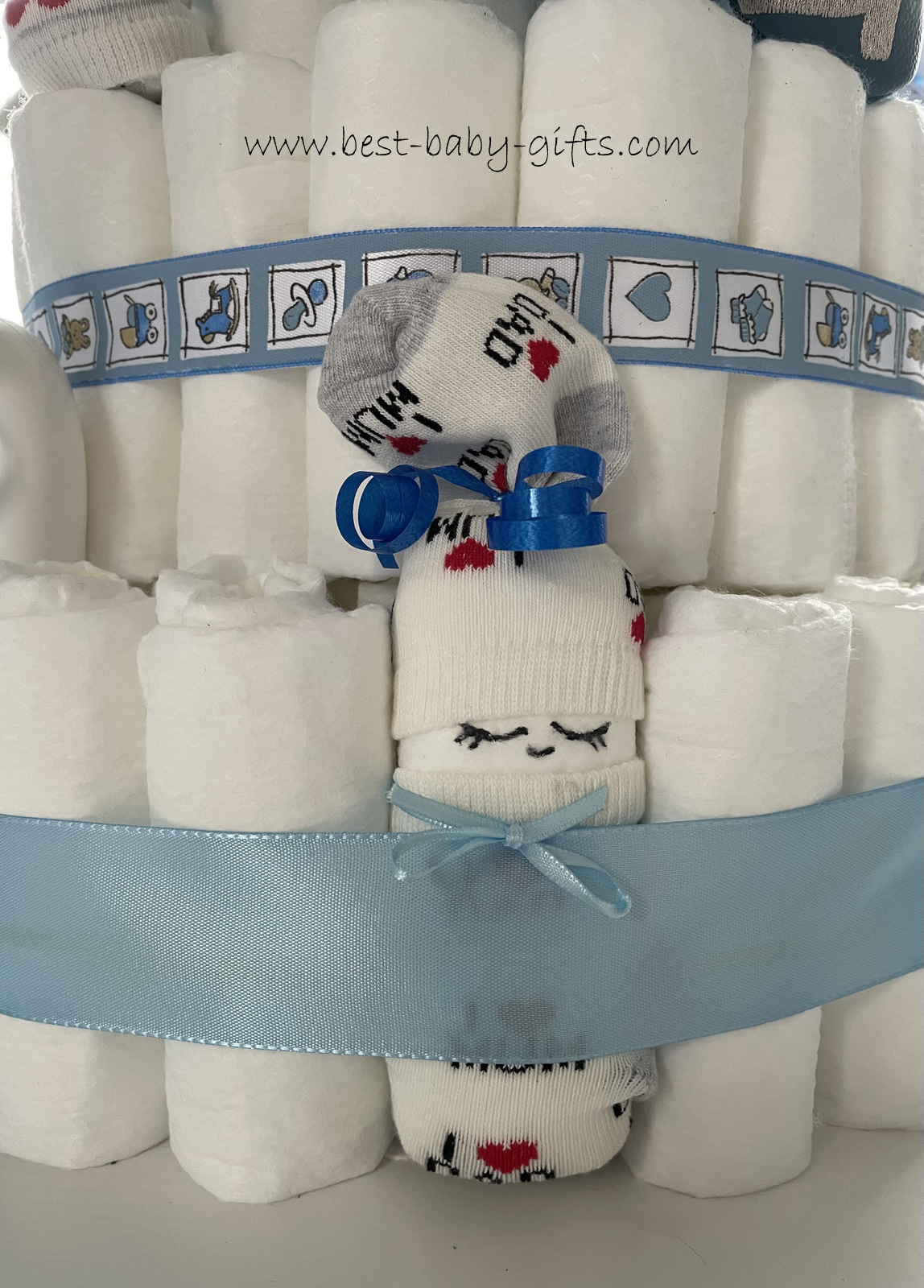 detail of a diaper cake with a diaper baby, blue ribbon