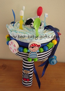a diaper cake on the form of a flower bouquet, the accessories are pirate themed such as a dark blue tight with pirates design, for baby boy