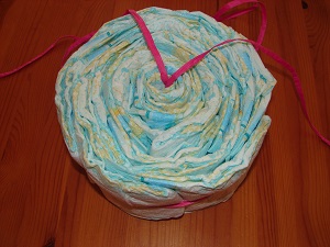 fully filled cake setting ring with diapers from above, ribbon hanging out