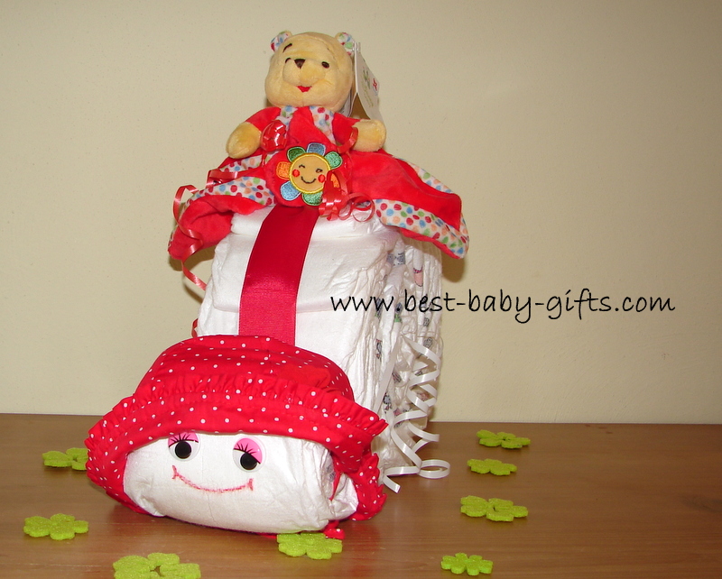 a diaper snail with a read hat and a plush Winnie on top