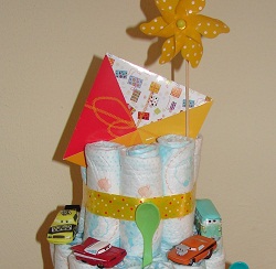 a colorful envelope sticking out the top of the diaper cake, also a pin wheel attached