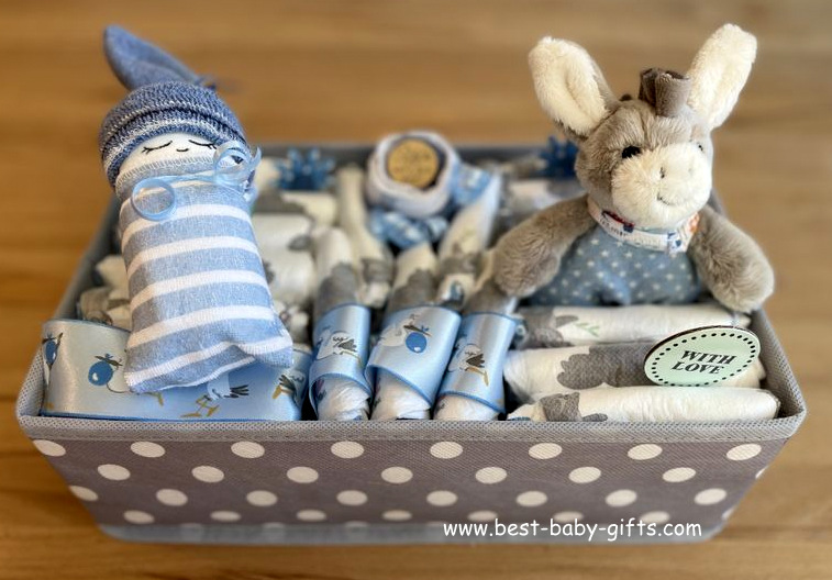 a gray polka dot closet organizer filled with diapers, baby goodies and a little cuddly donkey