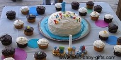 lots of yummy cupcakes circled around a birthday cake with 1 candle