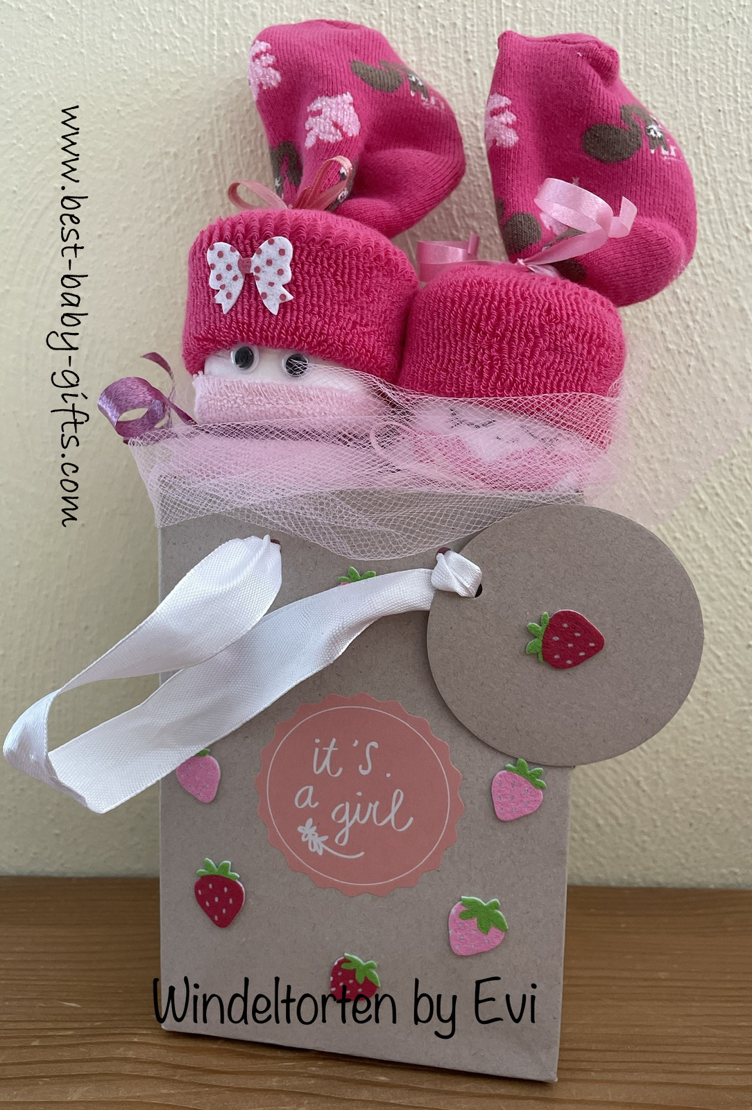 a gift bag with 2 diaper babies sticking out, pink colors