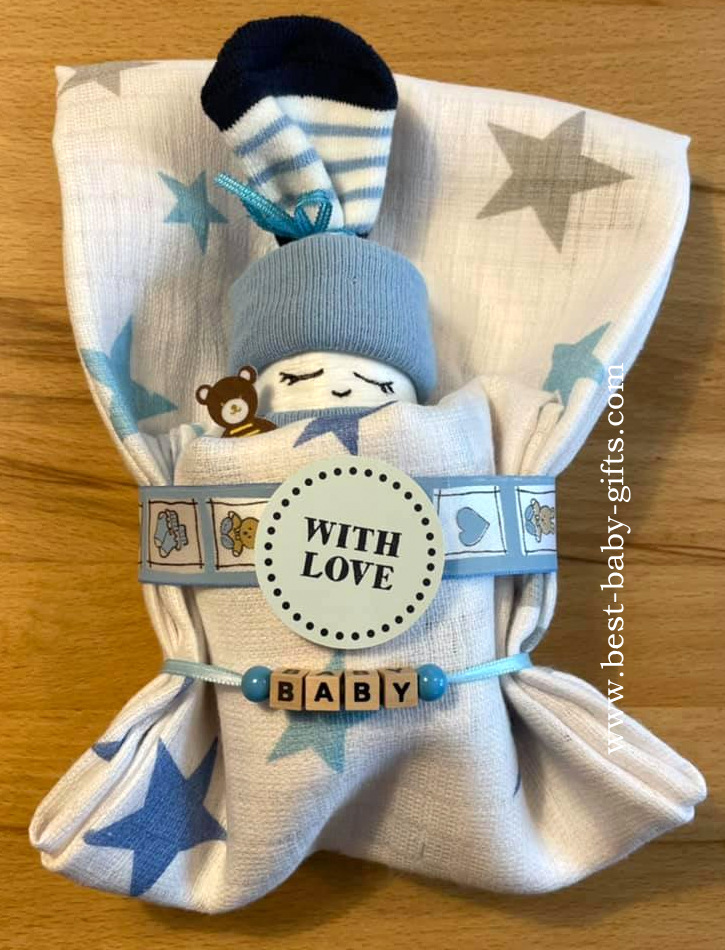 a blue diaper baby rolled in a burp cloth, decoration says "with love" and "baby"