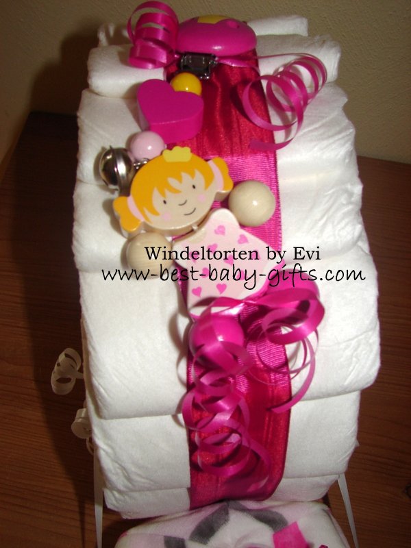 a pacifier chain clipped to the pink ribbon of the diaper snail