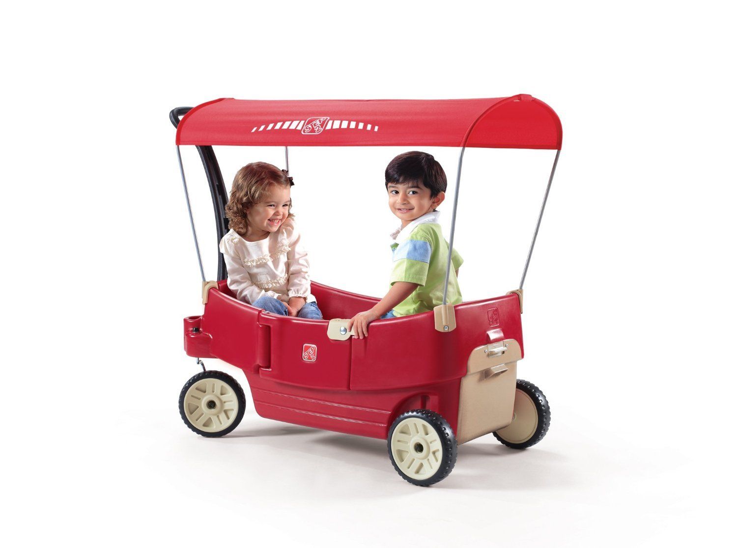 a Radioflyer wagon with a canopy, a boy and a girl are sitting inside