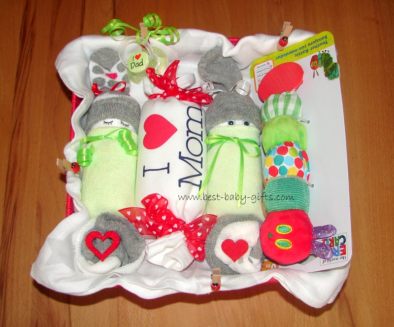 a beautifully homemade basket for mom and baby including two diaper babies and a baby onesie saying 'I love mom'