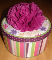 round box with lid and paper flower on top