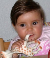 baby girl chewing on Sophie the Giraffe