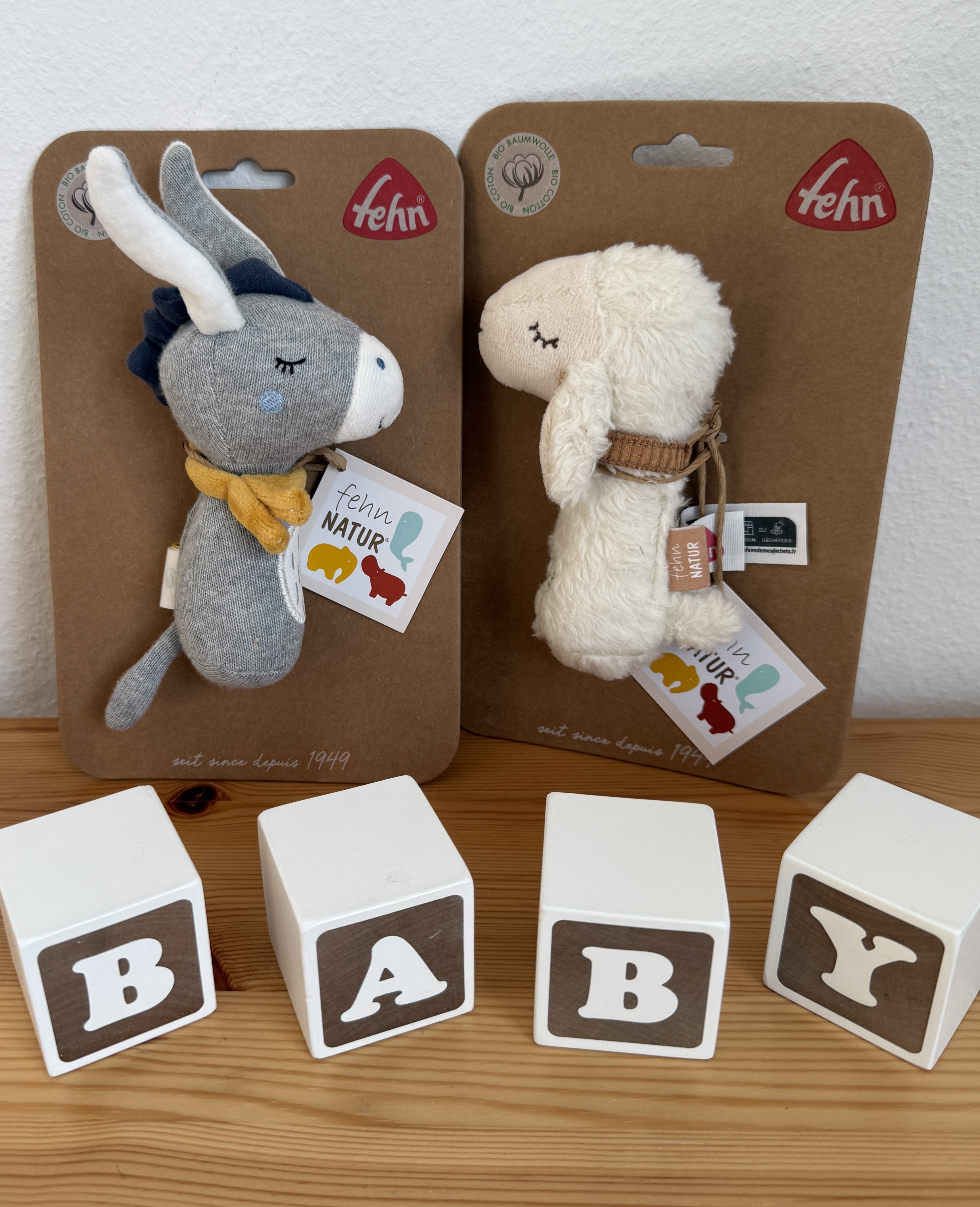 organic baby rattle toys by German company Fehn, a donkey and a sheep rattle