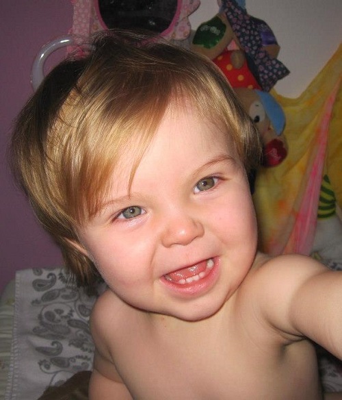 friendly baby girl smiling into the camera