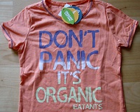 an orange baby t-shirt with text "don't panic, it's organic"