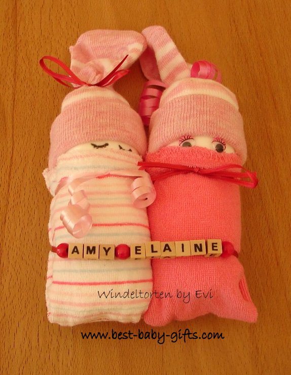 a pair of pink diaper babies with wooden letters for personalization