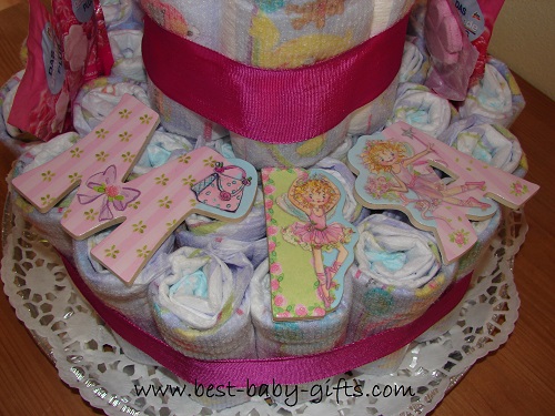 detail of a large diaper cake where you can see large  and beautifully decorated letters "MIA"