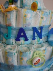 big blue letters on a diaper cake spelling "Jan"