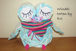 a diaper owl with a baby scarf