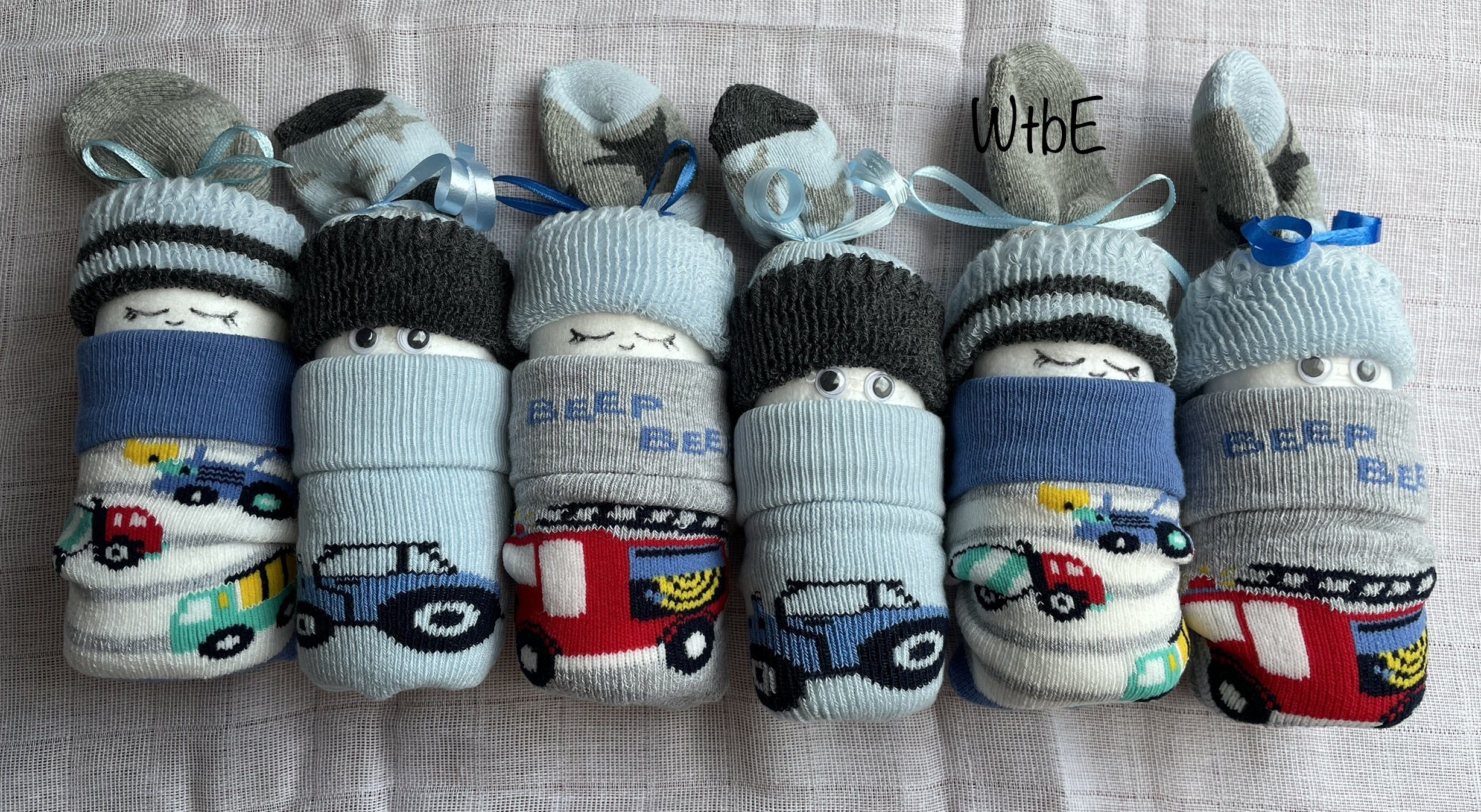 sock diaper babies for boy, 6 diaper babies laid out, made of socks only, the socks have car designs