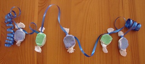 a garland of candies wrapped in green and blue paper