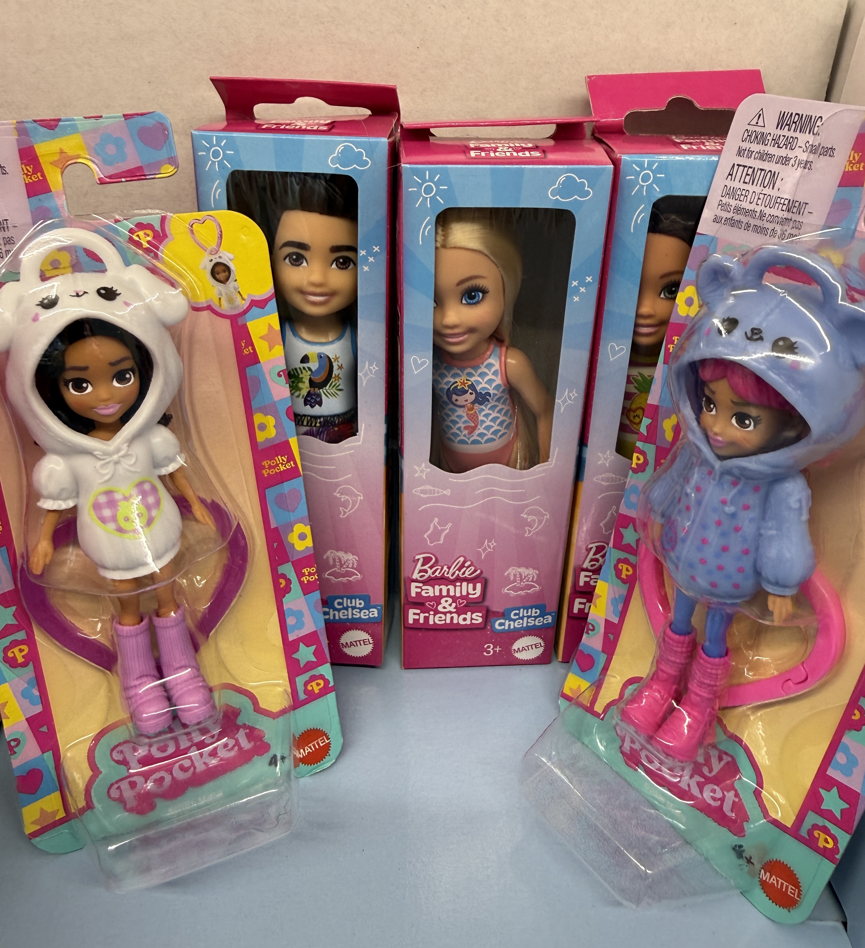 small Barbies and Polly Pocket dolls to include in a baby time capsule