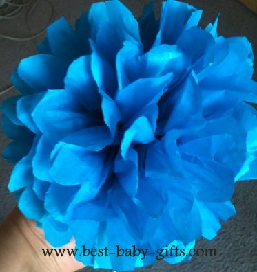 a tissue paper flower in a radiant blue color