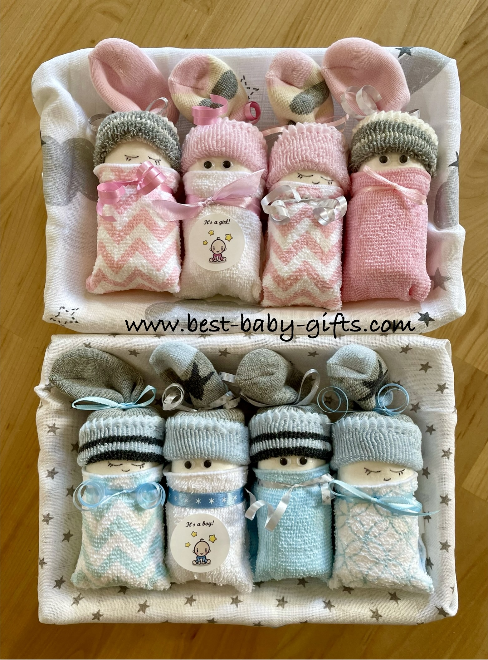 identical boxed diaper cakes for baby girl and boy in pastel colors with stickers "It's girl" & "It's boy"